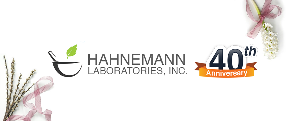 Hahnemann Labs' logo with 40th anniversary badge and light purple flowers on the corners